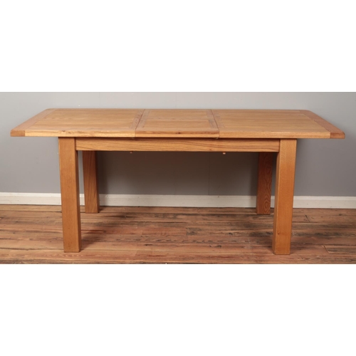 491 - A large light oak extending dining table and set of six matching chairs. Height 80cm, Width 90cm, Le... 