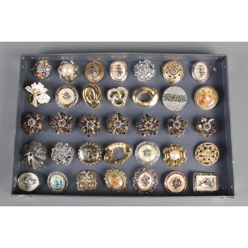 21 - A collection of thirty-five scarf rings. To include set of seven, Celtic style and floral examples.