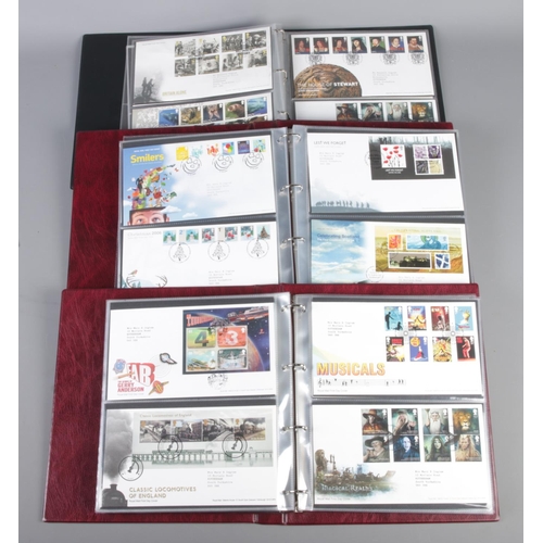 22 - Three Albums of Royal Mail first day covers. Including Grand Prix, Thomas The Tank Engine, Musicals,... 