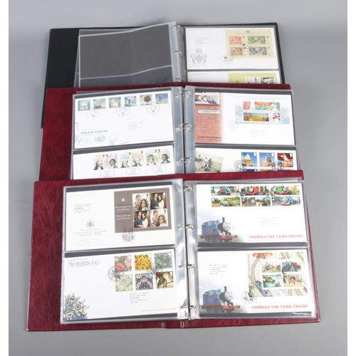 22 - Three Albums of Royal Mail first day covers. Including Grand Prix, Thomas The Tank Engine, Musicals,... 