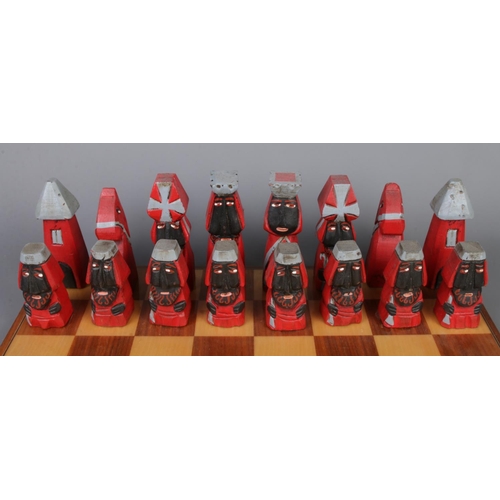 264 - Hand carved and painted wooden chess set and board, together with two wooden storage boxes. Board si... 