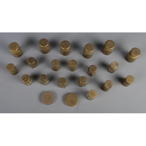 52 - A collection of brass money weights, to include £1, £5 and £10 examples.