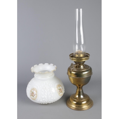 81 - An oil lamp along with floral shade.