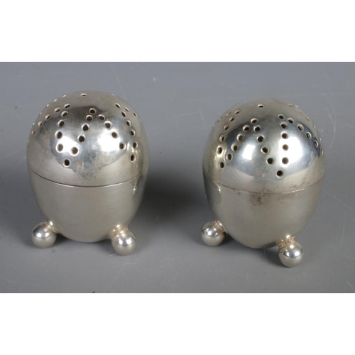 457 - A cased pair of silver pepperettes. Assayed Sheffield 1891. 46g.