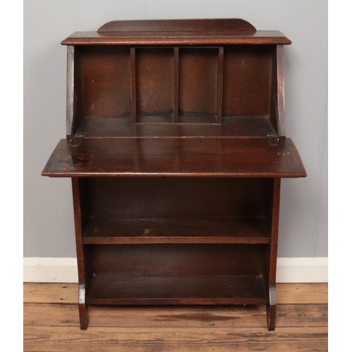 462 - A stained oak bureau with drop down top of small proportions, together with an oak child's chair. He... 