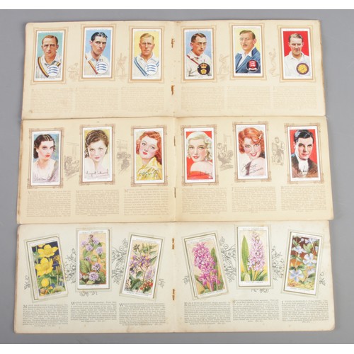 31 - An assortment of 1930's and 1940's cigarette picture card albums, issued by Player's and Wills's. To... 