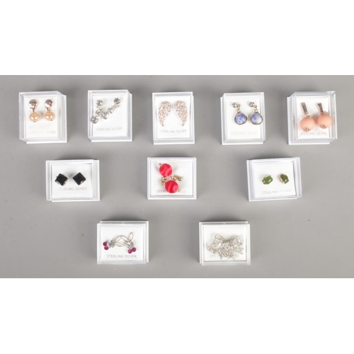 254 - Ten boxed pairs of costume jewellery earrings, including droplet, winged and bow example.