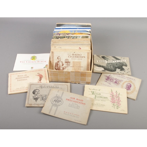 146 - A box of thirty five tea and cigarette card albums. Includes Wills, Brooke Bond, John Player & Sons ... 