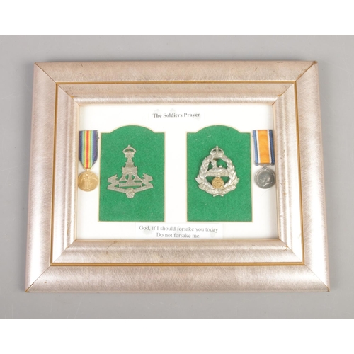 215 - A framed set of Yorkshire and Lancashire military cap badges mounted along with miniature medal repl... 