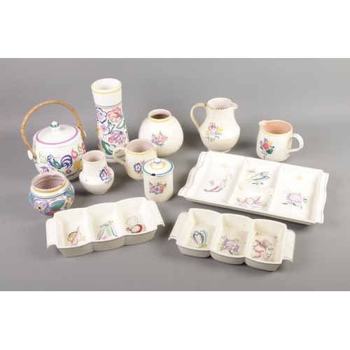 28 - A quantity of Poole pottery including hors d'oeuvres plates, biscuit barrel, jugs etc. Approx. 12 pi... 