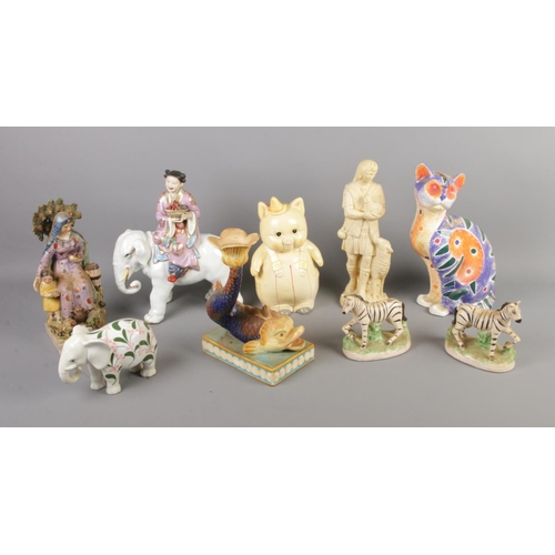 29 - A quantity of ceramic figures including pair of zebras, candlestick modelled as grotesque fish, orie... 