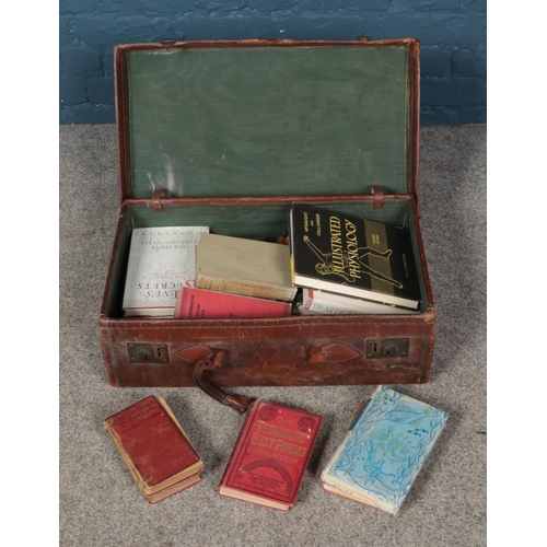 309 - A leather suitcase containing an assortment of books including several 20th century fiction examples... 