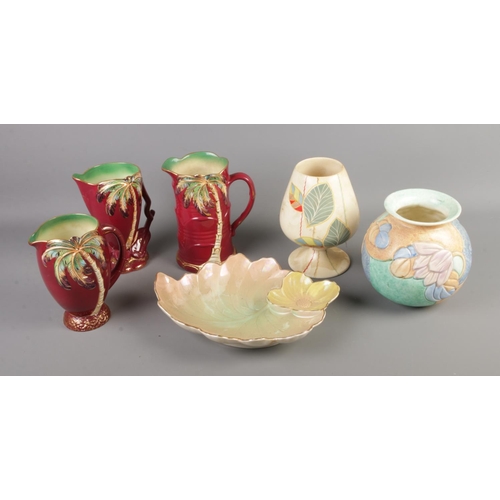 38 - Six pieces of Beswick ceramics including three palm tree jugs, two vases and decorative floral plate... 