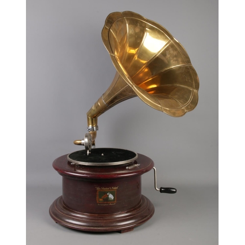 356 - Two Vintage 'His Masters Voice' wooden gramophones on circular bases. Both with brass funnels, one w... 