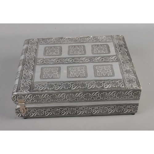 46 - A white metal velvet lined jewellery box featuring floral decoration and fitted interior. Approx. di... 