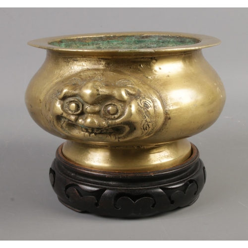 48 - An oriental style, possibly Chinese, brass censor on stand featuring animal head twin handles.