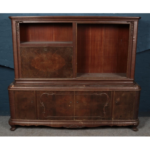 534 - A carved walnut side cabinet. (195cm x 166cm x 46cm)