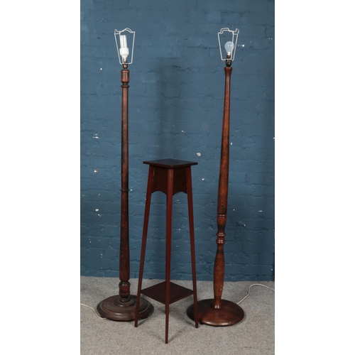 540 - A mahogany two tier jardiniere stand along with two turned wooden standard lamps.