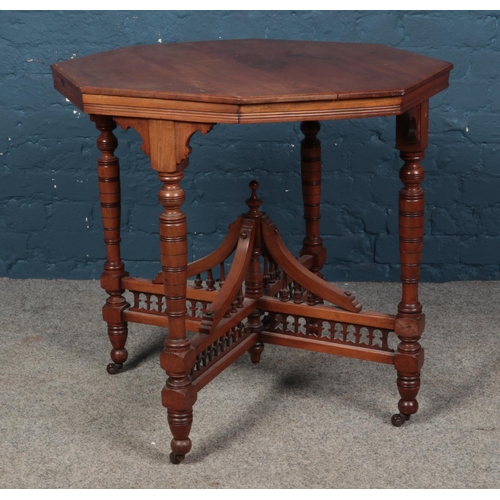 541 - An octagonal window table, on bobbin and galleried stretcher, raised on casters. Height: 74cm, Diame... 