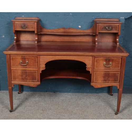 559 - An Edwardian carved mahogany desk with leather inset top. Raised on slender tapering legs. (107cm x ... 