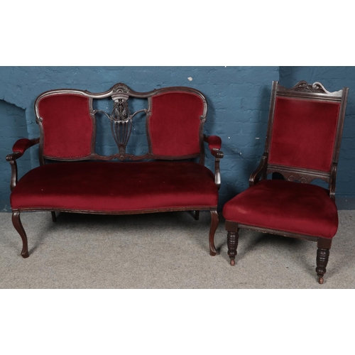 560 - A carved mahogany part salon suite. Comprising of two seat sofa and chair.