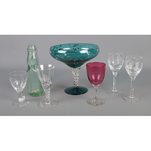 13 - A quantity of assorted glassware including Japanese Ramune bottle (with marble), coloured and acid e... 