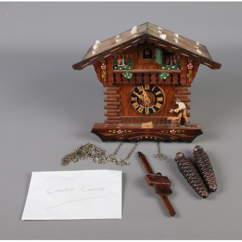 16 - A German Regula pendulum cuckoo clock in the form of a carpenters house.