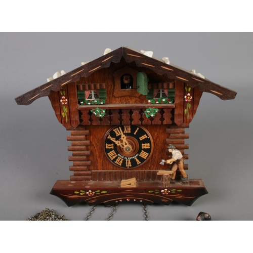 16 - A German Regula pendulum cuckoo clock in the form of a carpenters house.