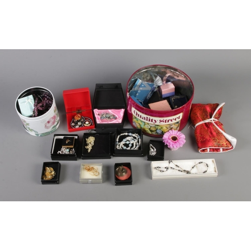 25 - Two tins of boxed costume jewellery to include necklaces and bracelets, etc.