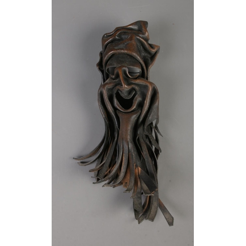 27 - A Yoruba tribal staff along with leather ritual mask formed as a bearded figure.