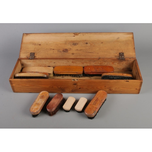 29 - A pine brush box along with 13 assorted brushes.