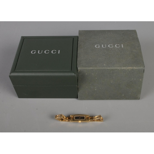 357 - A Gucci ladies 3900L yellow metal wristwatch with box.