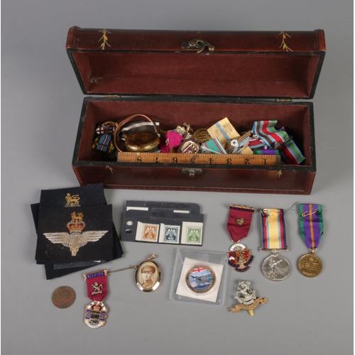 7 - A box of collectables including rolled gold locket, German WWII stamps, Masonic medals, commemorativ... 