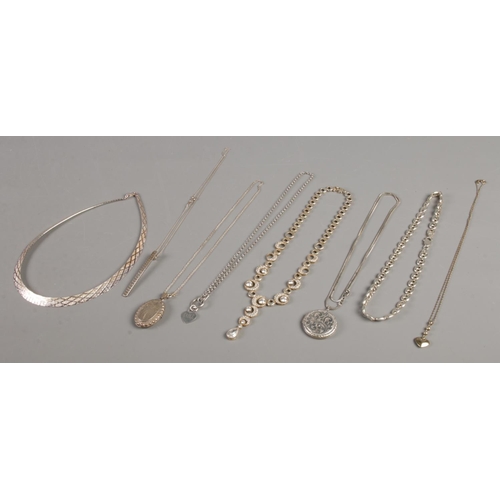 409 - A good collection of silver chains, pendants, lockets and necklets. Total weight: 126g