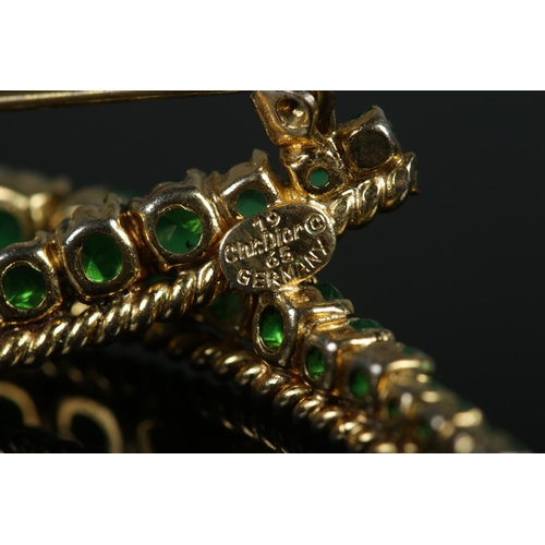 412 - A vintage Christian Dior bow brooch, set with green stones and rope twist decoration. Stamped and da... 