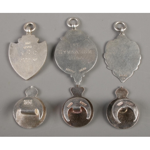 424 - Three silver fobs together with three silver Royal Army Reserve badges. Fobs assayed for Birmingham ... 