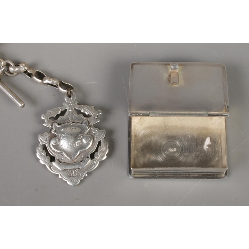 474 - A quantity of silver including vesta case in the form of a book (19.1g), Albert Chain and fob (fob h... 