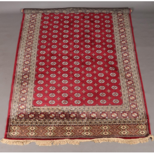 117 - A red ground cashmere Bokhara carpet. 200cm x 300cm.