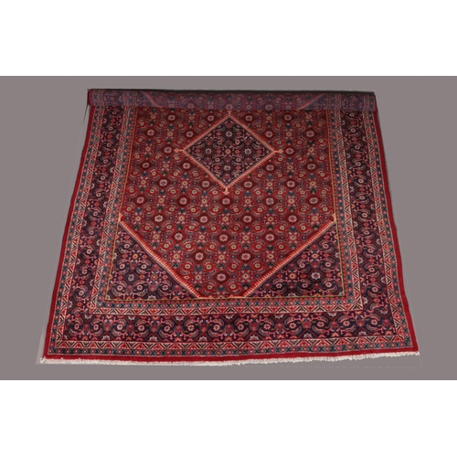 121 - A very large red ground Persian carpet with all over floral design and central medallion. 400cm x 28... 