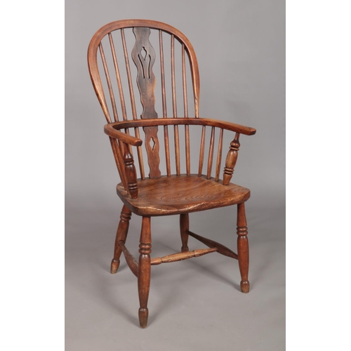 126 - A 19th century ash/elm Windsor arm chair with pierced slat.