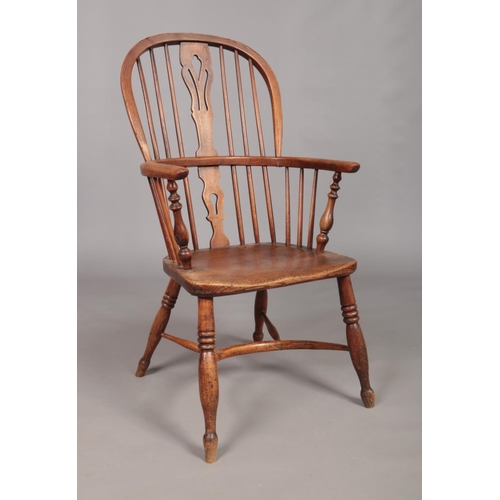 127 - A 19th century ash/elm Windsor arm chair with crinoline stretcher and pierced slat. Maker's mark for... 