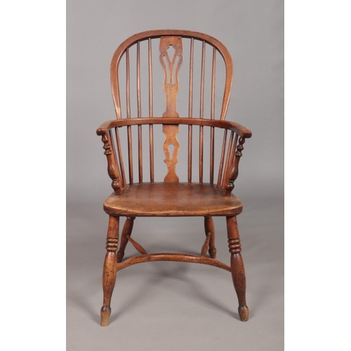 127 - A 19th century ash/elm Windsor arm chair with crinoline stretcher and pierced slat. Maker's mark for... 