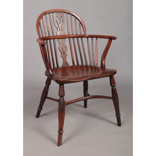 130 - A 19th century ash/elm and yew wood Windsor arm chair with crinoline stretcher and pierced slat. Tot... 