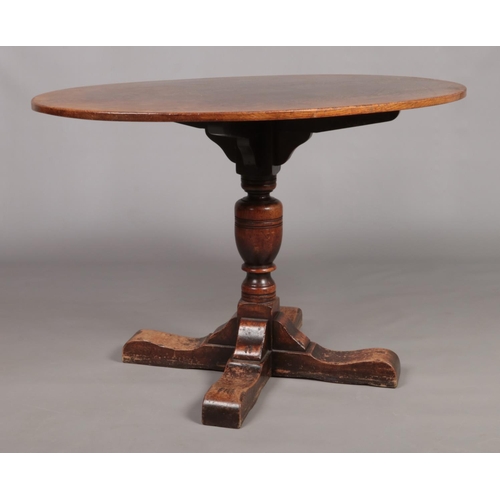 131 - A Titchmarsh and Goodwin oak centre pedestal dining table with oval top.