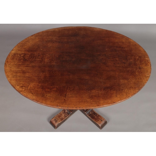 131 - A Titchmarsh and Goodwin oak centre pedestal dining table with oval top.