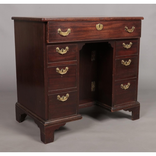 132 - A Georgian mahogany knee hole desk. Height 79cm, Width 84cm, Depth 51cm.