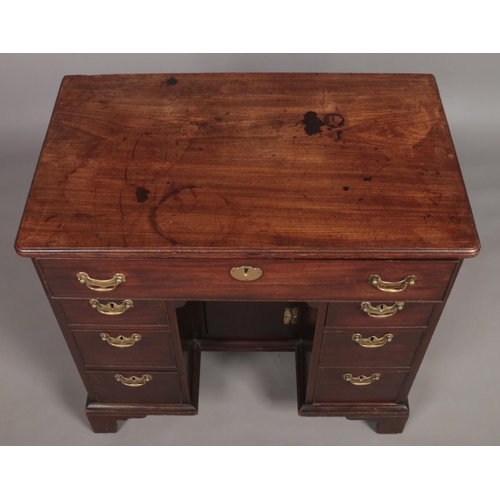 132 - A Georgian mahogany knee hole desk. Height 79cm, Width 84cm, Depth 51cm.