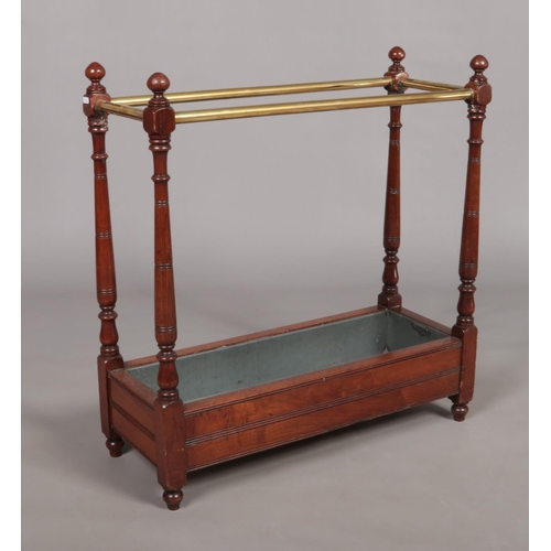 134 - A Victorian mahogany and brass stick stand with liner. 67.5cm x 71.5cm x 26cm.