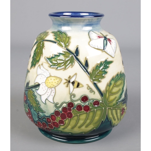 24 - A Moorcroft pottery vase decorated in the Fruit Garden pattern designed by Nicola Slaney. Height 15c... 