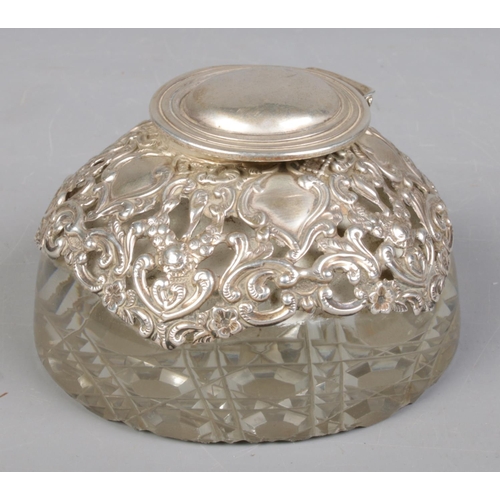 36 - An Edwardian silver mounted glass ink well with hinged cover and hobnail cut base. Assayed Birmingha... 